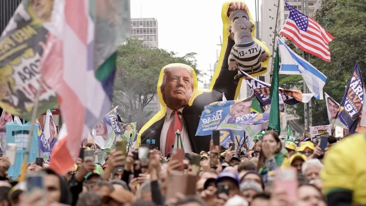 Boneco inflável de Donald Trump segura representação de Lula com uniforme de presidiário em ato na Avenida Paulista